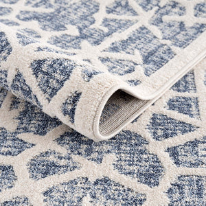 Tapis scandinave bleu et crème avec des franges tressées Nora